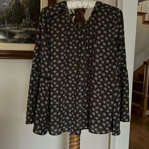 Polyester blouse, loose and blousy. Long sleeves that bell halfway down.